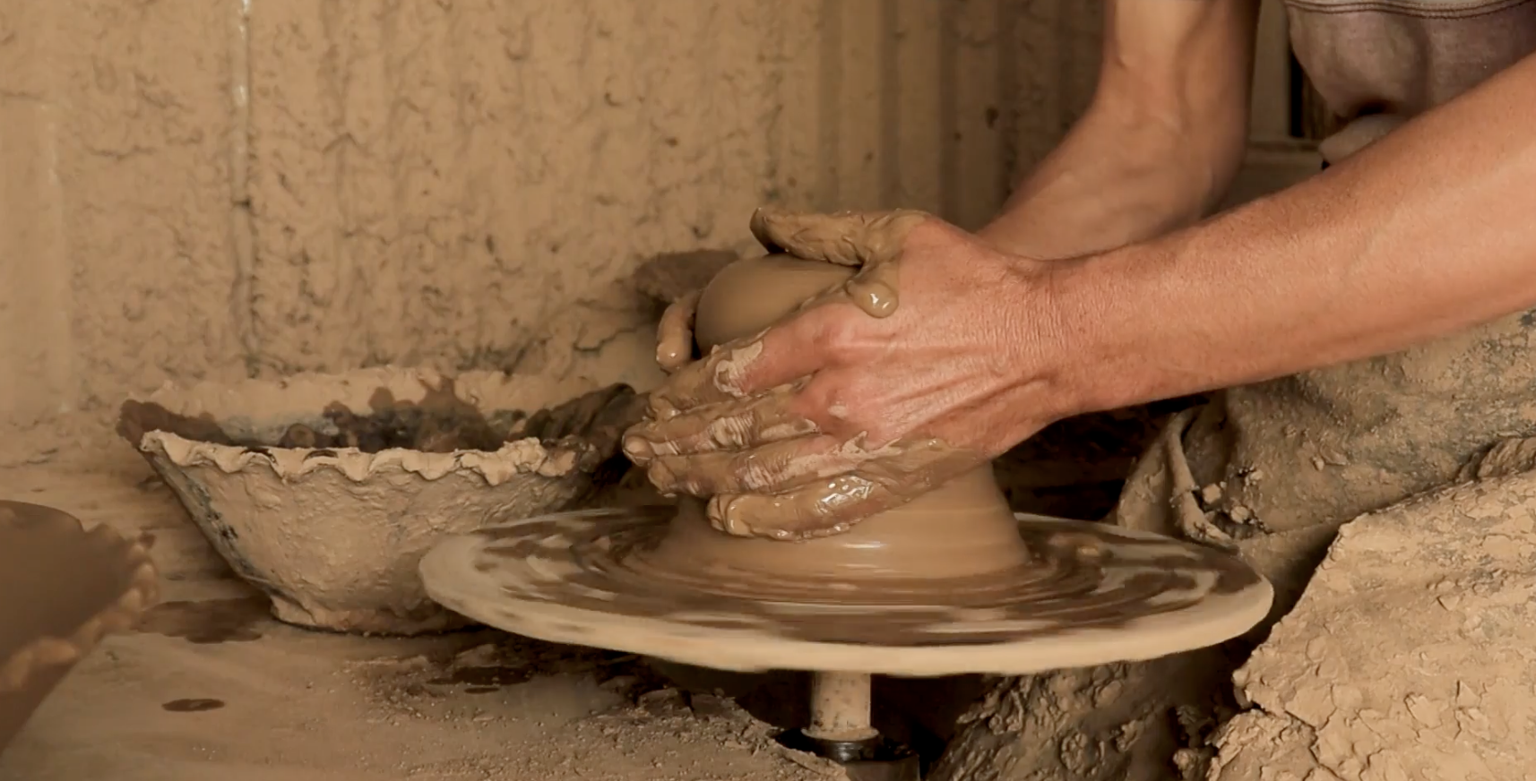 Potter shaping clay by hand, scene 8
