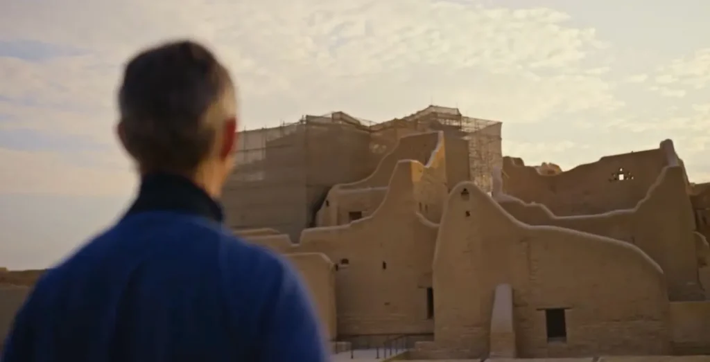 Historic mud-brick walls of At-Turaif in Diriyah, Saudi Arabia, illuminated by warm evening light