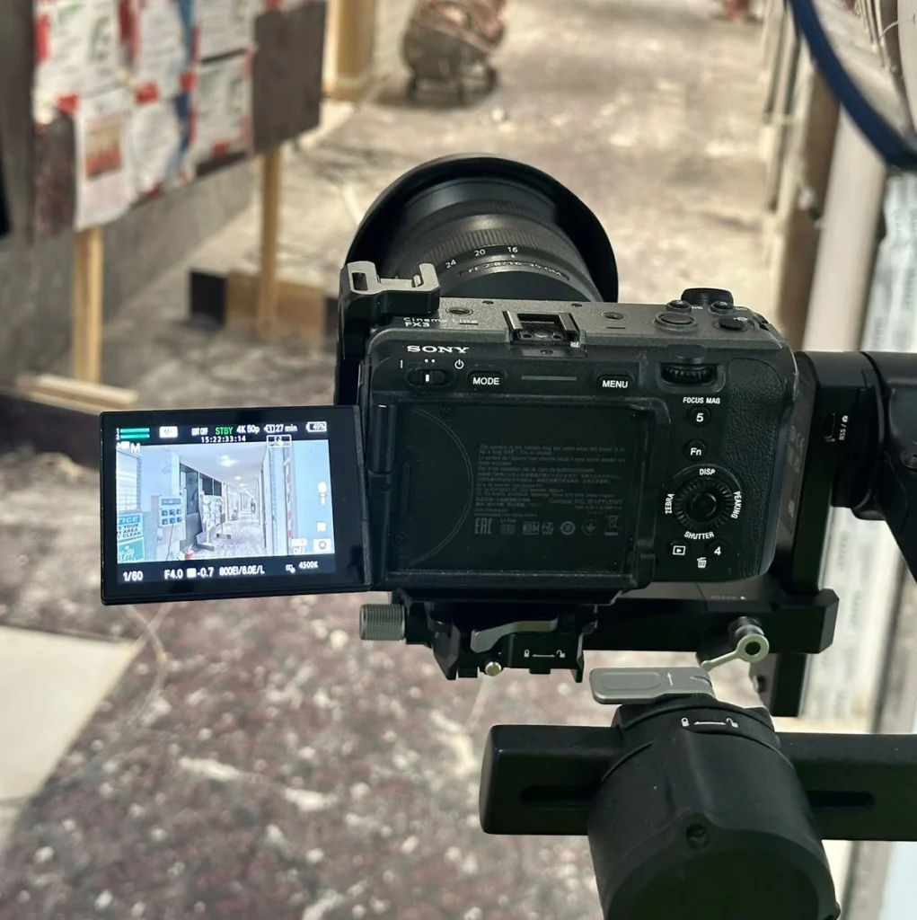 A professional cinema camera rigged and positioned on site for filming an office fit out transformation project.