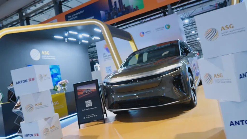 Al Sharif Group exhibition booth at the 25th WPC Energy Congress in Riyadh, featuring an electric vehicle and company displays.