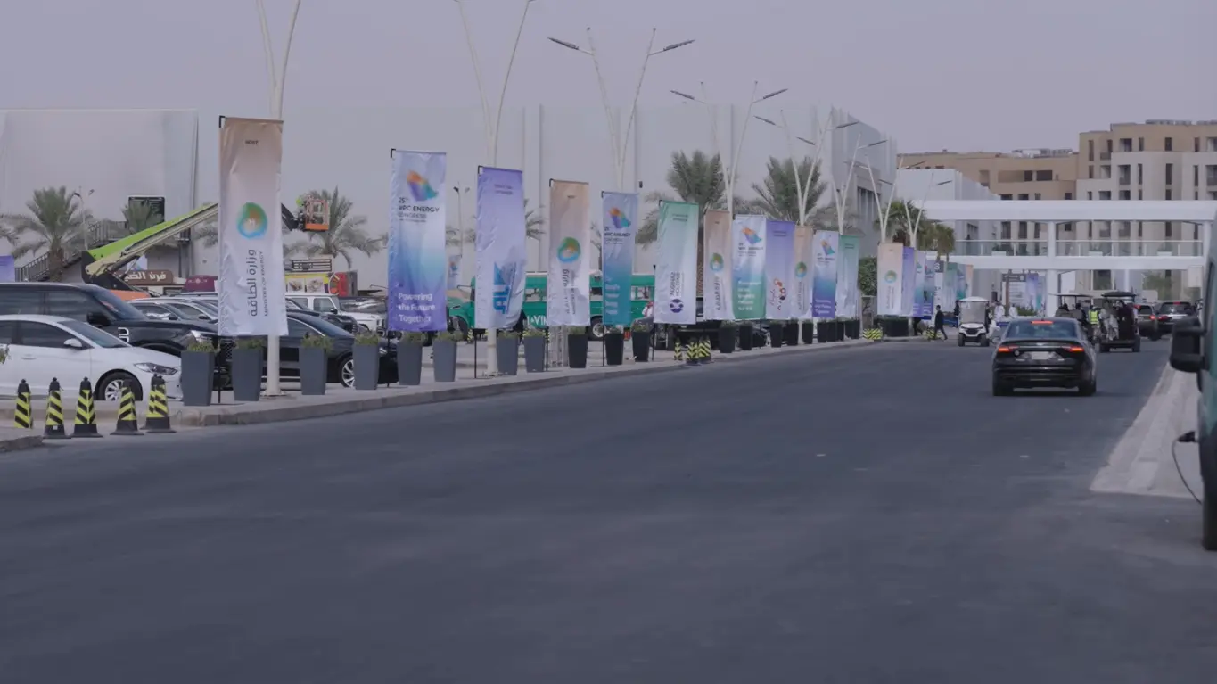 Road leading to the 25th WPC Energy Congress venue in Riyadh, lined with event banners and parked vehicles.