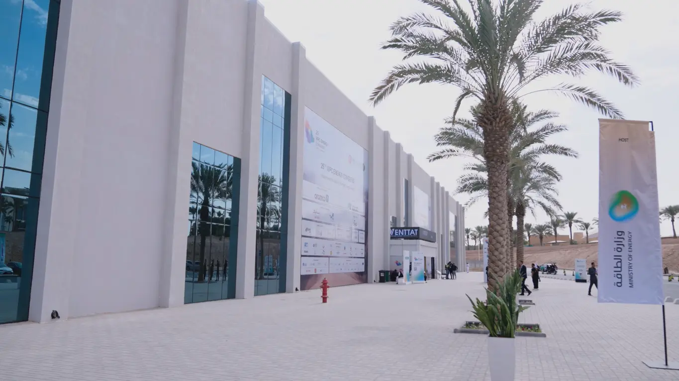 Exterior of the 25th WPC Energy Congress exhibition venue in Riyadh, with palm trees and event signage.
