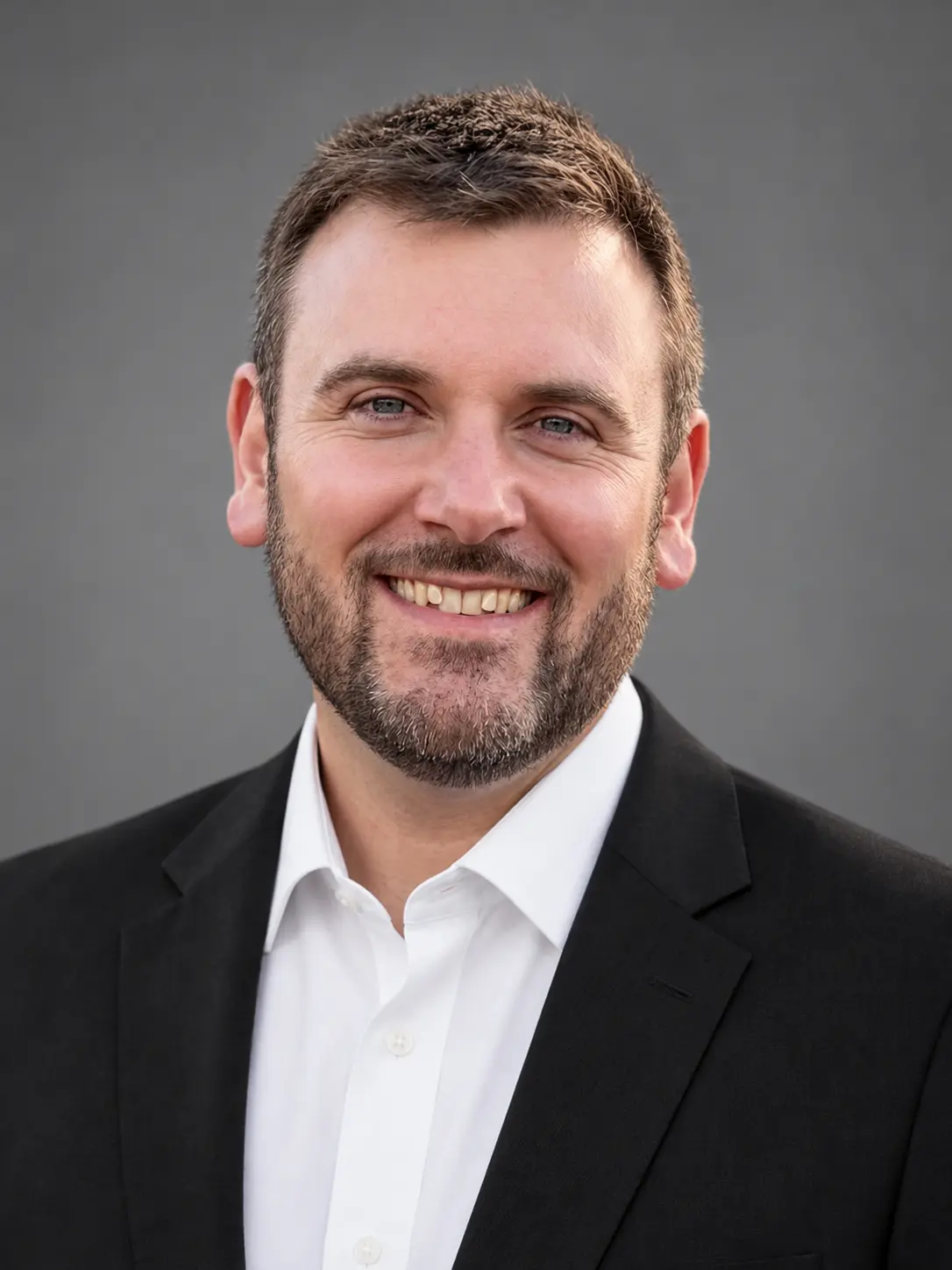 Professional portrait of Rob Hill, Underwater Director of Photography, against a neutral grey studio background.